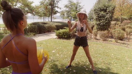 An Exciting and Fun Summer Day Friends Engaging in Play with a Beach Ball in the Park