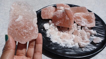 Blocks of Rock Salt in plate. Himalayan Rock salt unrefined with minerals beneficial for health and ayurvedic rituals