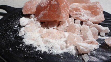 Blocks of Rock Salt in plate. Himalayan Rock salt unrefined with minerals beneficial for health and ayurvedic rituals