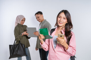 A diverse group of young adults with gadgets is getting ready for their travel plans