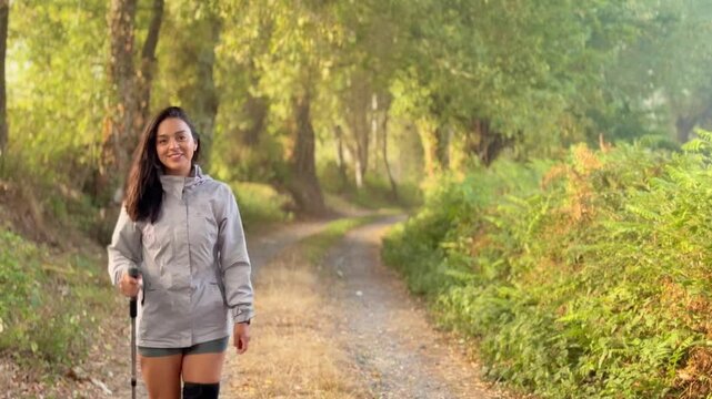 Young woman walking the Camino de Santiago from Sarria, joyfully exploring forest trails and city streets during her spiritual and cultural pilgrimage in northern Spain