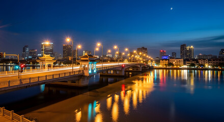 Fototapeta premium Cityscape at Night: Illuminated Bridge and Skyline Reflection in China