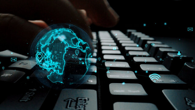 A close-up view of hands typing on a keyboard with a futuristic digital globe overlay, symbolizing global connectivity, innovation, and modern communication technology. Xenic