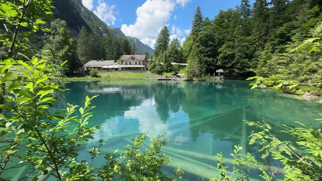 Crystal-clear Blausee lake in Switzerland, where the water is so transparent you can see fish swimming below. Pristine alpine nature, peaceful atmosphere, and stunning natural beauty. Kandergrund 