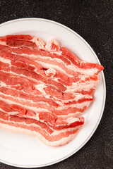 Bacon slice lard with meat slices pieces pork tenderloin portion size natural product tasty snack fresh delicious gourmet food background on the table rustic top view copy space