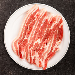 Bacon slice lard with meat slices pieces pork tenderloin portion size natural product tasty snack fresh delicious gourmet food background on the table rustic top view copy space
