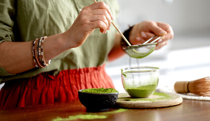 Woman Sifting Matcha Tea