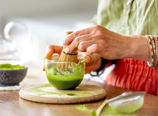 Woman Whisking Matcha Tea