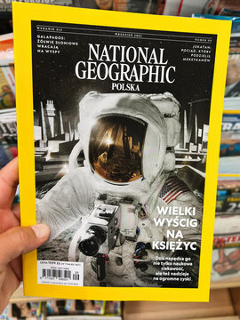 Hand holding a National Geographic issue featuring an astronaut on the moon cover