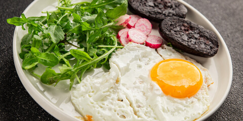 Eggs breakfast black pudding, egg, vegetables, arugula portion size natural product tasty snack fresh delicious gourmet food background on the table rustic top view copy space