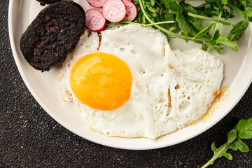 Eggs breakfast black pudding, egg, vegetables, arugula portion size natural product tasty snack fresh delicious gourmet food background on the table rustic top view copy space