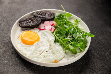 Eggs breakfast black pudding, egg, vegetables, arugula portion size natural product tasty snack fresh delicious gourmet food background on the table rustic top view copy space