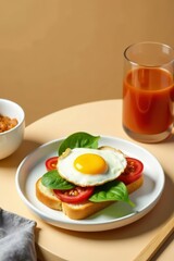 Delicious fried egg and tomato open-faced sandwich on toasted bread with spinach garnish, served alongside a glass of refreshing juice.