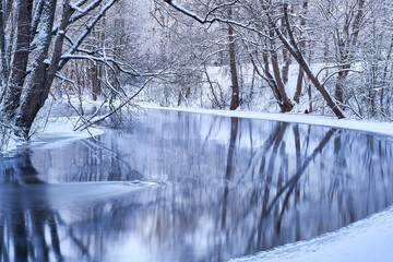 river in winter forest
