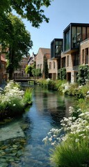 Obraz premium Quaint canal running through a charming European town, with modern and traditional buildings lining the waterway. Lush greenery and white flowers border the canal