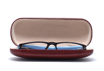 SQUARE SHAPE EYE GLASS ON BROWN BOX FRONT CLOSE VIEW ON ISOLATED WHITE BACKGROUND.