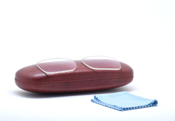 EYE GLASS LENS WITH EYE GLASS BOX ON ISOLATED WHITE BACKGROUND WITH SELECTIVE FOCUS.