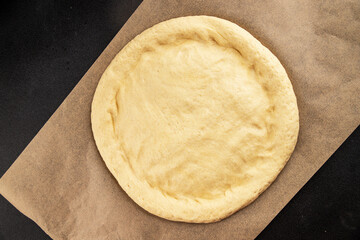 Raw pizza dough making pizza base tasty snack fresh delicious gourmet food background on the table rustic top view copy space