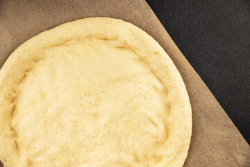 Raw pizza dough making pizza base tasty snack fresh delicious gourmet food background on the table rustic top view copy space