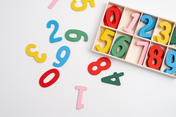 Bright wooden numbers on a colored background. Close-up of colorful wooden numbers back to school.