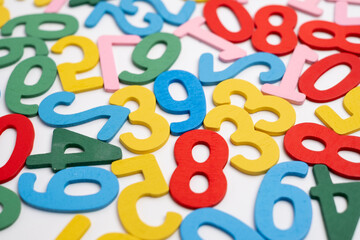 Fototapeta premium Bright wooden numbers on a colored background. Close-up of colorful wooden numbers back to school.
