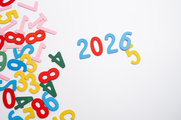 Colored numbers of the calendar for 2026 on the background. Happy New Year 2026 card.