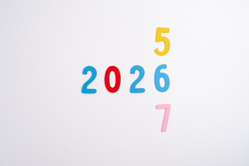 Colored numbers of the calendar for 2026 on the background. Happy New Year 2026 card.
