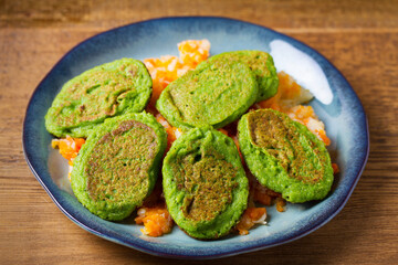 Vegetable fritters, pancakes or cakes on blue plate