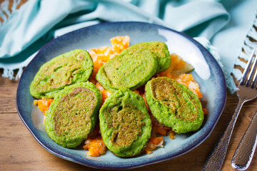 Vegetable fritters, pancakes or cakes on blue plate