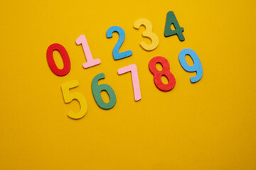 Bright wooden numbers on a colored background. Close-up of colorful wooden numbers back to school.