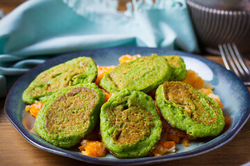 Vegetable fritters, pancakes or cakes on blue plate