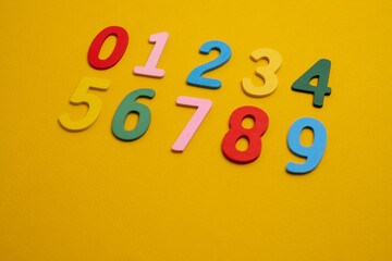 Bright wooden numbers on a colored background. Close-up of colorful wooden numbers back to school.