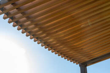 Minimalist sunshade design made of wooden slats for architecture projects. Wooden pergola canopy...