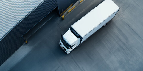 Aerial View of a Semi-Truck at a Logistics Warehouse Dock. Transportation and supply chain concept for freight companies, logistics services, or industrial real estate.