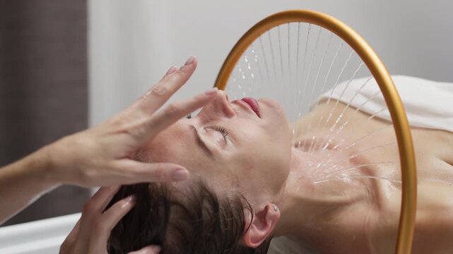 Woman enjoying hydromassage therapy in a serene spa setting, water cascading gently over her head, promoting relaxation and rejuvenation through aqua massage techniques - Powered by Adobe