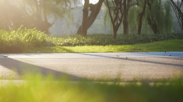 Young man jogging on a city bridge with tall buildings in the background during morning light