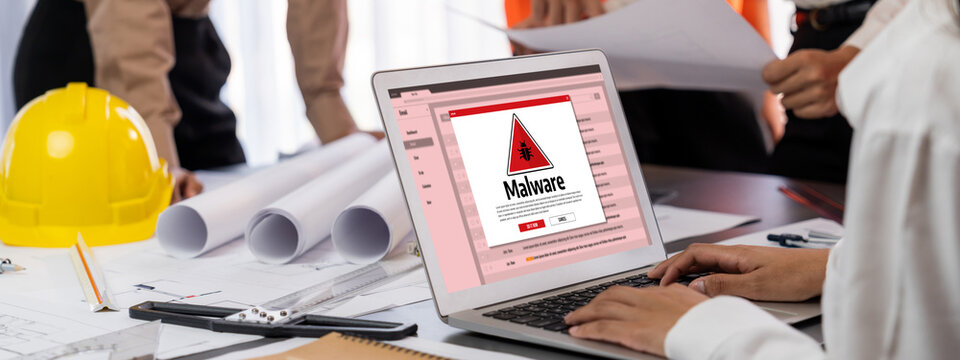 Cyber attacking concept. Malware alert showing on computer screen display scam and threat detection on computer system or online server to be removed brisk.