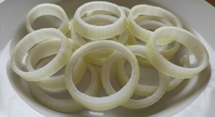Raw Onion Rings on a White Plate