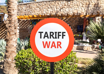 Trade tariff war symbol. Concept word Tariff war on beautiful red and white road sign. Beautiful...