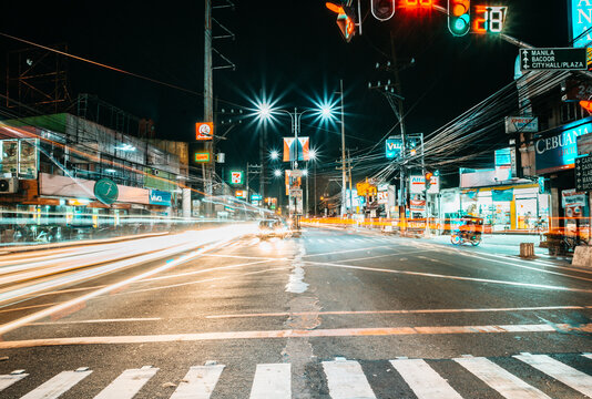 Nighttime Long Exposure Urban Intersection with Light Trails along Aguinaldo Highway, Imus, Cavite, Philippines