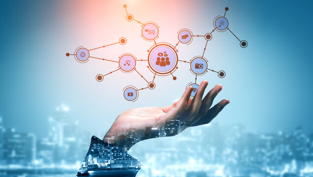 This image portrays a hand reaching out to network connections, symbolizing digital interaction and collaboration in a modern city backdrop, ideal for tech-related themes. Tessel - Powered by Adobe