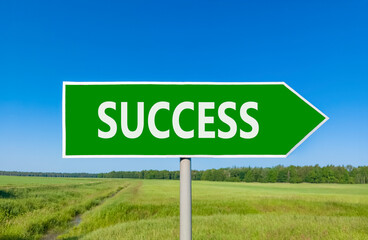 Success symbol. Concept word Success on beautiful green road sign. Beautiful blue sky green grass and forest peaceful nature background. Business success concept. Copy space.