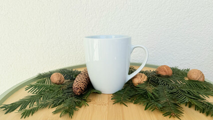 White Mug With Pine Cones And Walnuts On Evergreen Branches — Winter Decoration Mockup With Copy Space For Banner, Branding And Template Design