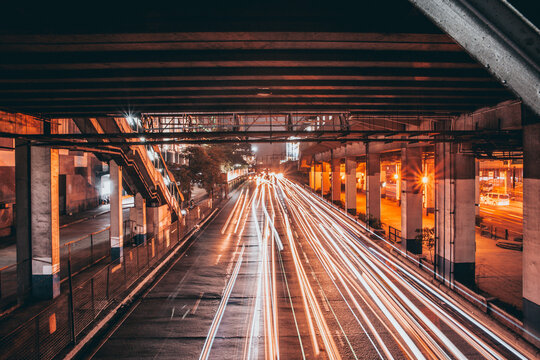 Underpass at Night with Orange Traffic Light Trails of EDSA, Metro Manila, Philippines