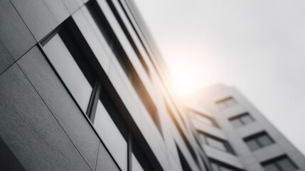 Obraz premium Large building with many windows and a sun shining on it