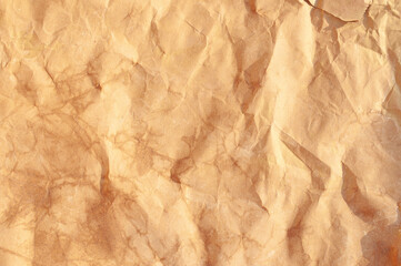 Crumpled brown paper texture revealing unique patterns and hues in natural light