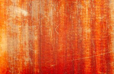 Vibrant orange and red textured surface with scratches and patterns
