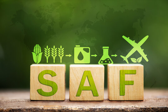 Sustainable Aviation Fuel (SAF) text in wooden and icons on natural background.Alternative fuel for aircraft made from renewable raw materials such as used vegetable oil concept.
