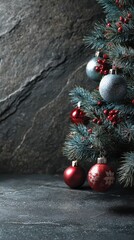 Elegant Christmas tree adorned with colorful ornaments against a textured stone background