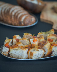 Freshly baked focaccia bread slices with golden crust and airy texture on a tray